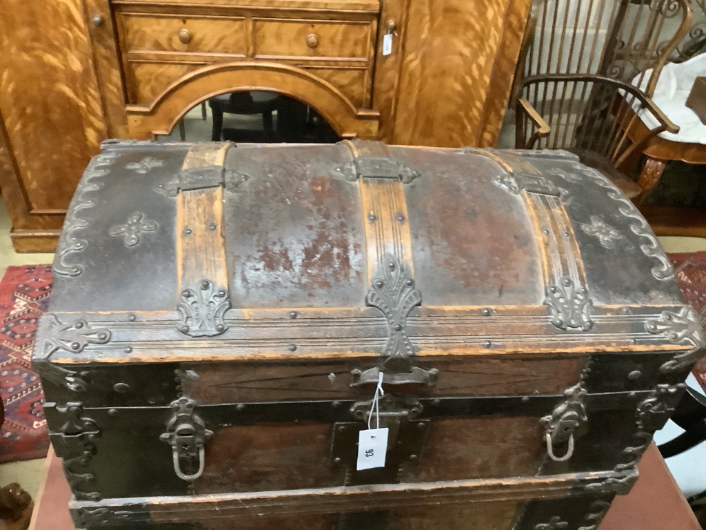 A late Victorian leather and metal mounted dome top trunk with scrap-work interior, length 76cm, depth 48cm, height 62cm